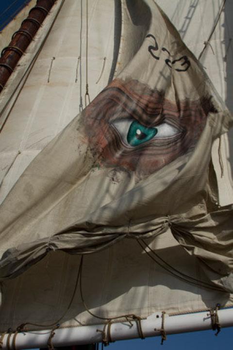 A sail with an image of a turquoise human eye on it