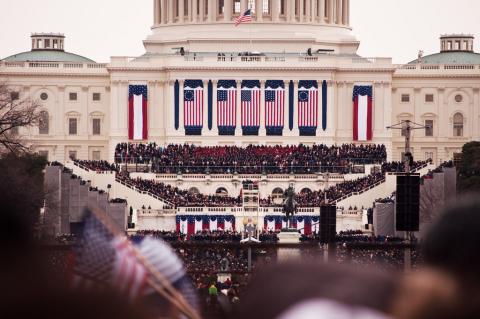 57th Presidential Inauguration, 21 January 2013. View of the U.S. Capitol building from the crowd, with people waving flags.