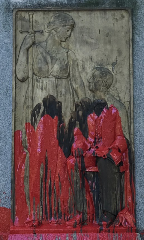 Close-up of the statue base of “Silent Sam” on campus at UNC-Chapel Hill with ink and blood running down (Image by permission of the Workers Union at UNC-CH).