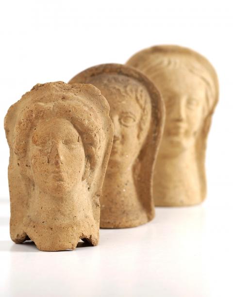 Three Roman votive offering representing faces. Credit: Wellcome Collection. CC BY 4.0: https://wellcomecollection.org/works/vy2engnk