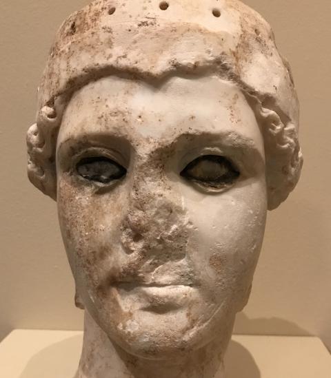 A sculpture of a man's face, missing a nose