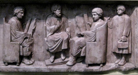 Relief found in Neumagen near Trier, a teacher with three discipuli (180-185 AD). Photo courtesy of Wikimedia commons.