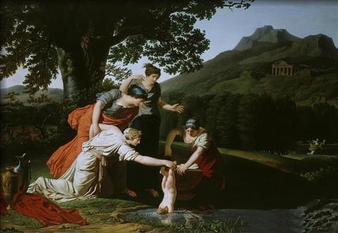 Beneath a tree, three women look on as another woman holds a nude infant by one ankle, dangling him into the water of a stream below.