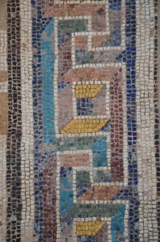 Preserved portion of a mosaic floor, with blue, red, white, and gold tesserae, discovered near Corinth which adorned the dining room of a luxurious Roman house, 2nd or early 3rd century AD, Archaeological Museum of Ancient Corinth, Greece" by Following Hadrian is licensed under CC BY-SA 2.0