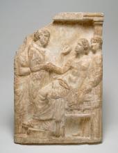A white marble stele featuring two standing women and two seated women. The central standing woman holds the hand of the central seated woman. 