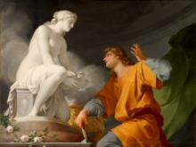 On the left, a white statue of a seated, nude woman holding a bird looks down at a man in an orange toga, who looks up at her with his left hand raised.