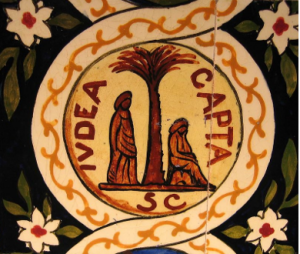 A white circle on a black background with green leaves and white flowers. Around the circle is a yellow vine border, and in the middle there is a palm tree. On the left side of the tree, an abstract figure in drapery stands, and on the right side, a simil