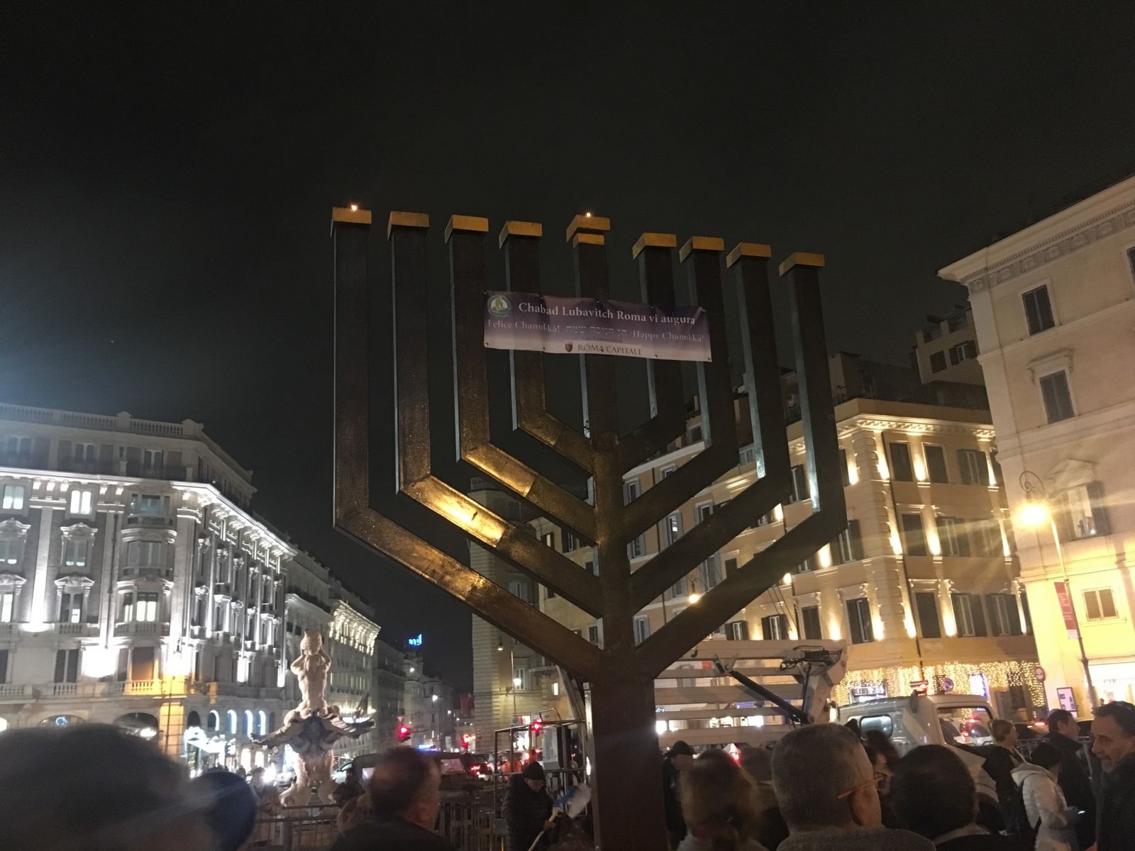 The lighting of the menorah in Piazza Barberini on the first night of Hanukkah with the Fontana del Tritone in the background. Image by Catherine Bonesho, unpublished.