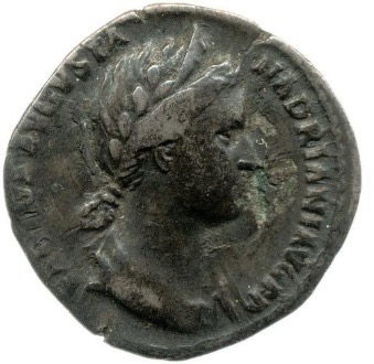 A gray coin featuring an image of Sabina. Her hair is braided into a low chignon bun.